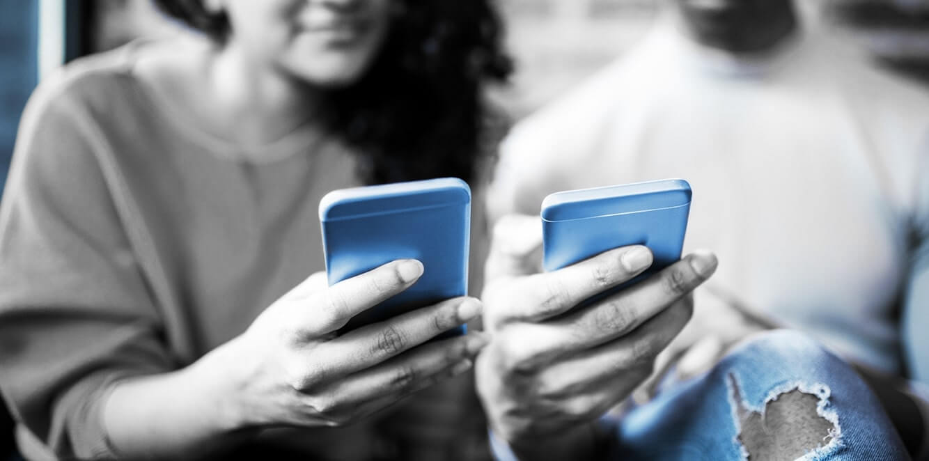 2 People Looking at Phones