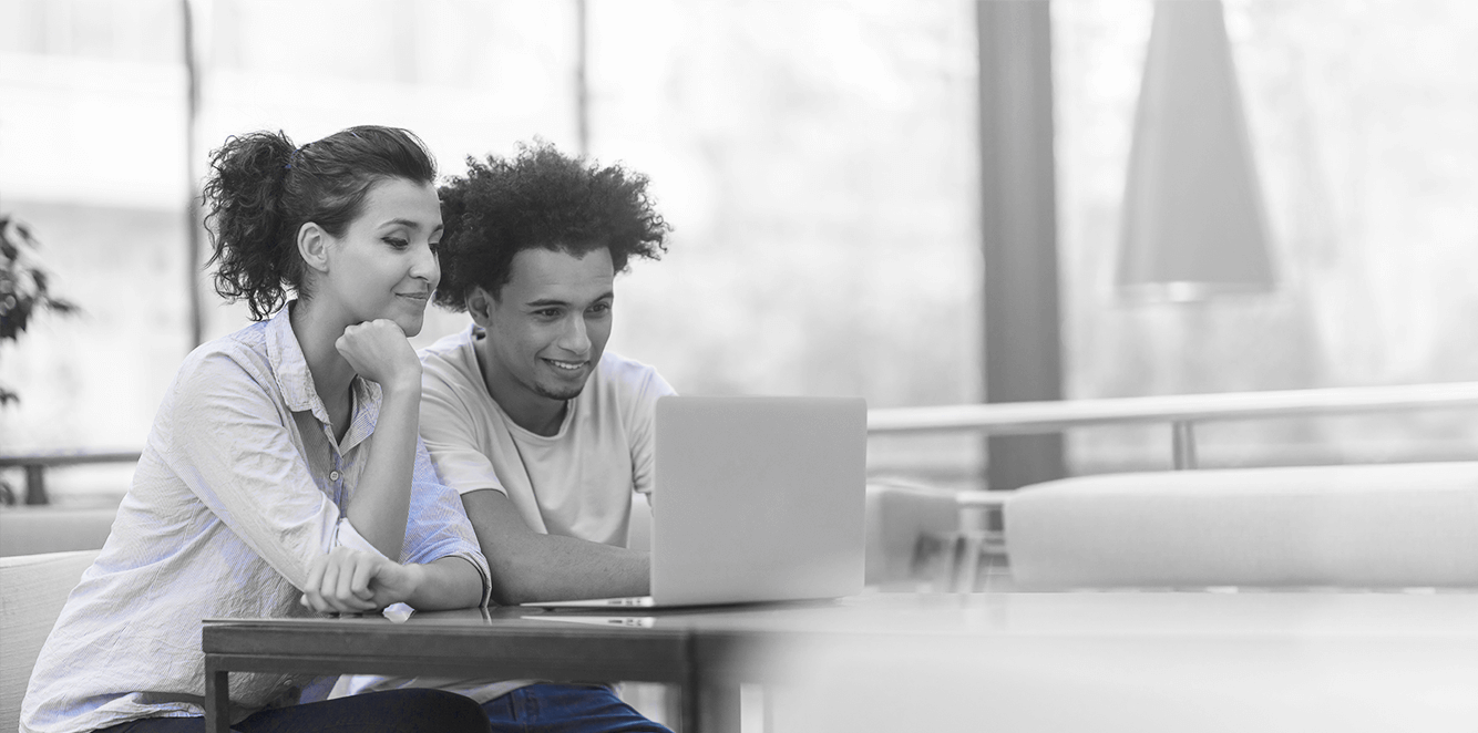 Two people looking at a computer