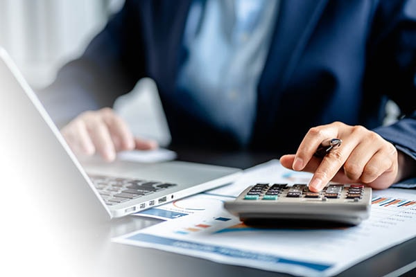 Person using calculator at desk