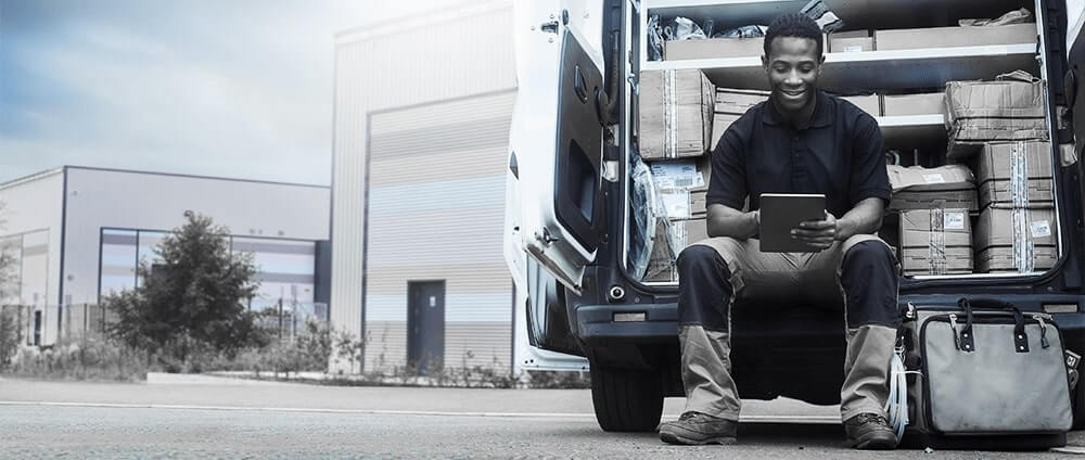 A person sitting in the back of a work truck